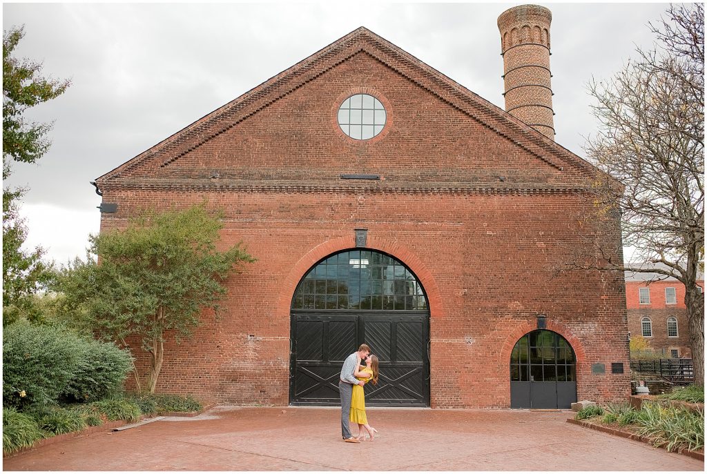 Engagement couple in yellow dress at historic tredegar doors in richmond virginia