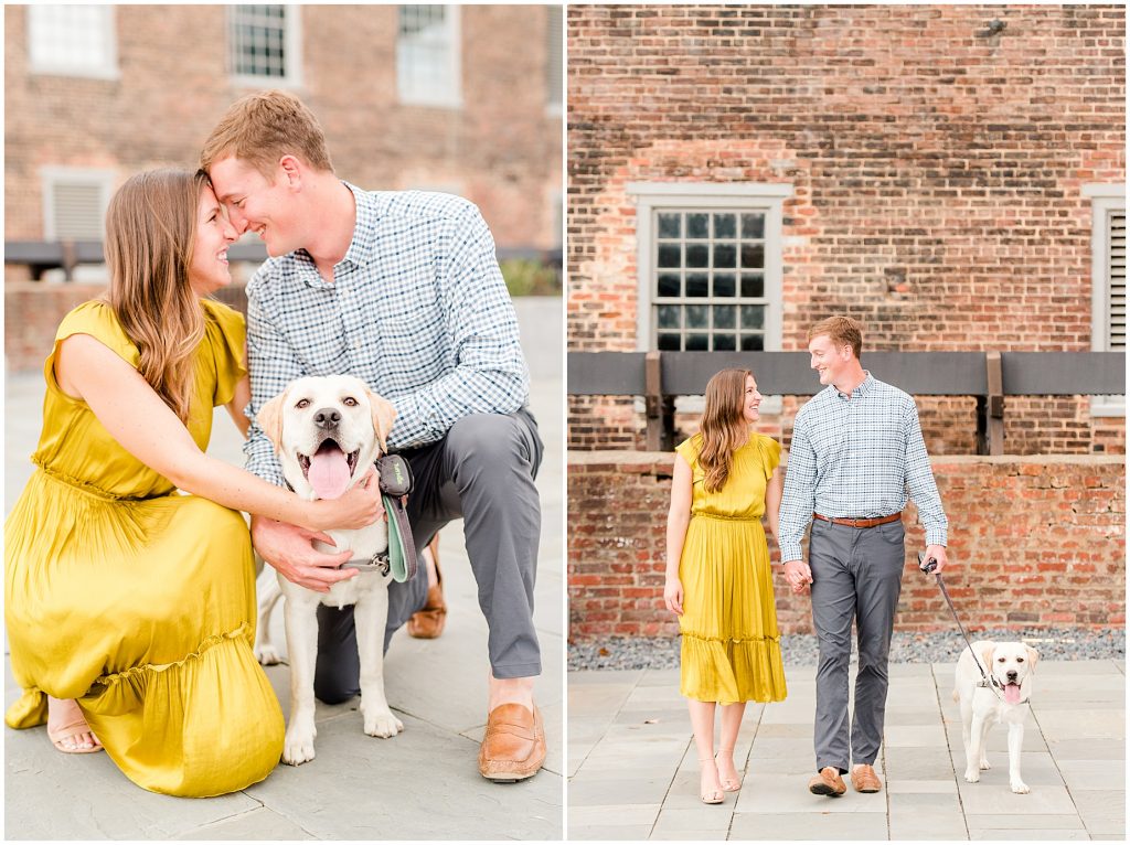 engagement couple walking with lab dog at tredegar museum in richmond virginia