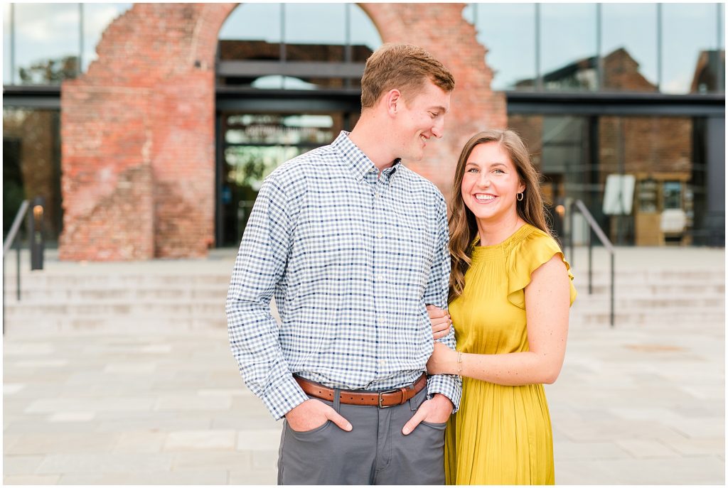 engagement couple in front of historic brick arch at tredegar museum in richmond virginia
